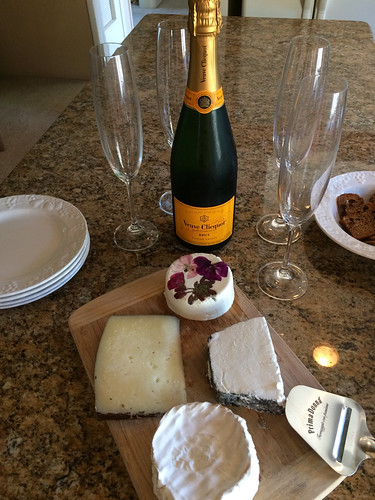 Veuve Clicquot and our cheese board filled with Sea Spring Island chevre, Pave de Jadis, Delice de Cremiers, and Cinco Lanzas
