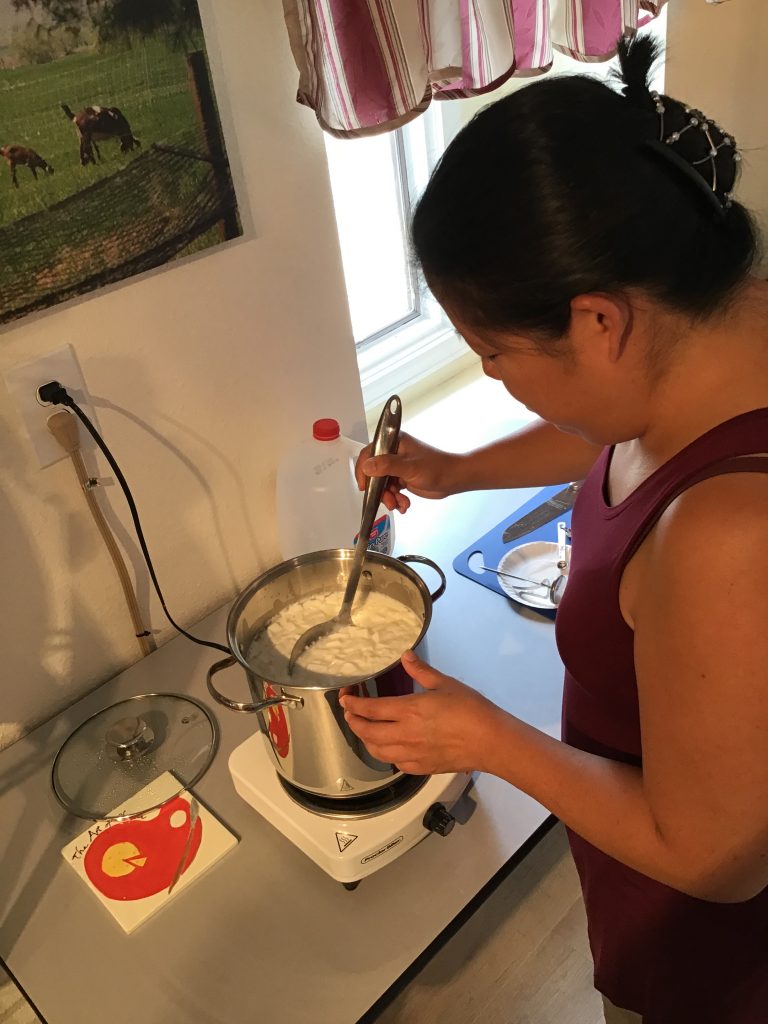 Jinnee practicing the horizontal cuts as she cuts the curds