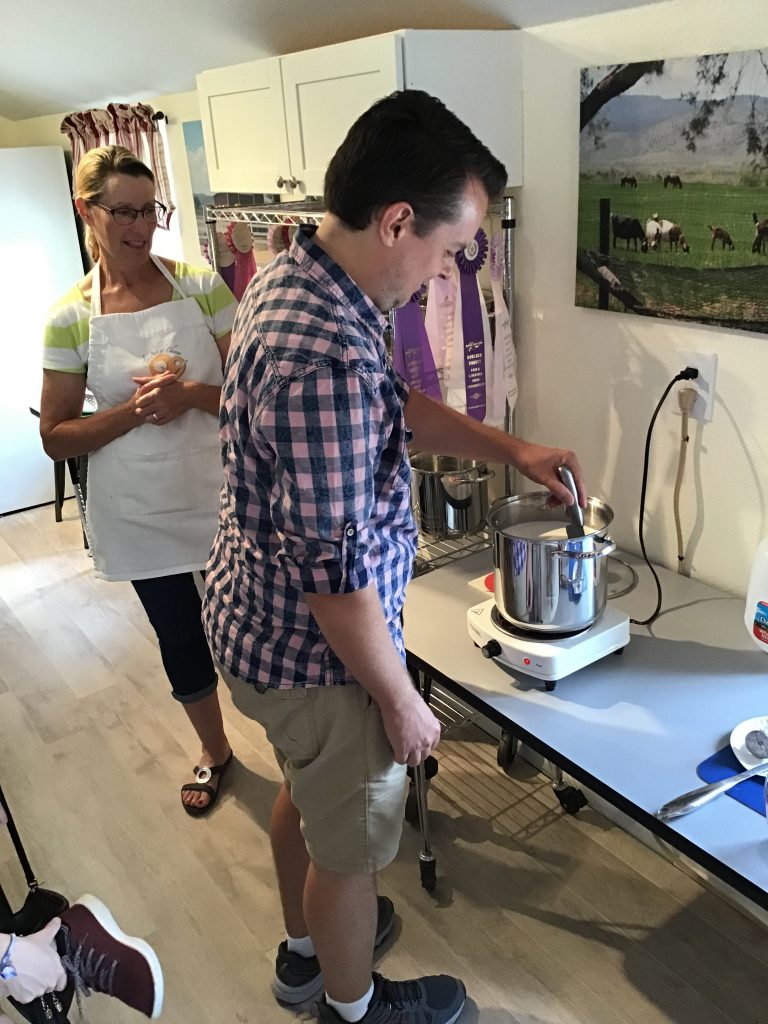 Neil cutting the curds while Kate looks on