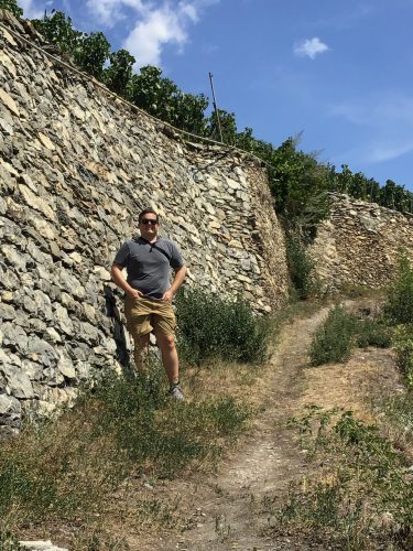 Neil posing near the rock wall